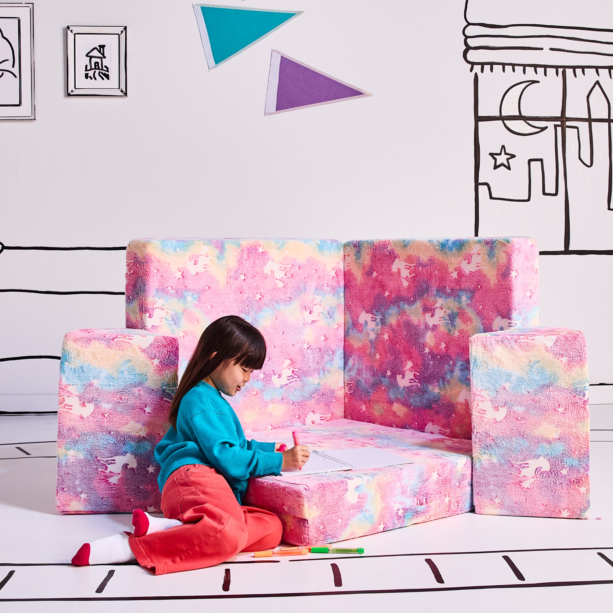 Girl drawing and coloring in the Rockstar stage configuration in the unicorn color. 