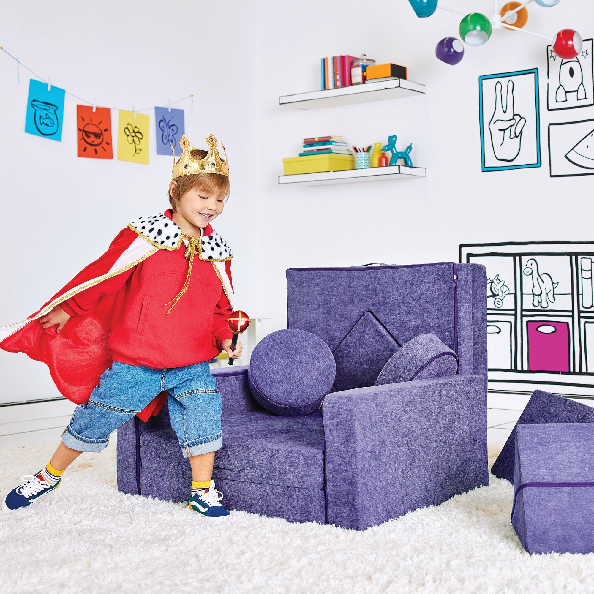 Boy dressed as a king playing by the Royal Throne configuration of the Yourigami Kids Play Fort in cosmic-purple color