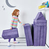 Girl folding and stacking the pieces of the Yourigami Kids Play Fort in cosmic-purple against the corner of the playroom for storage