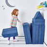 Girl folding and stacking the pieces of the Yourigami Kids Play Fort in sapphire-caves against the corner of the playroom for storage